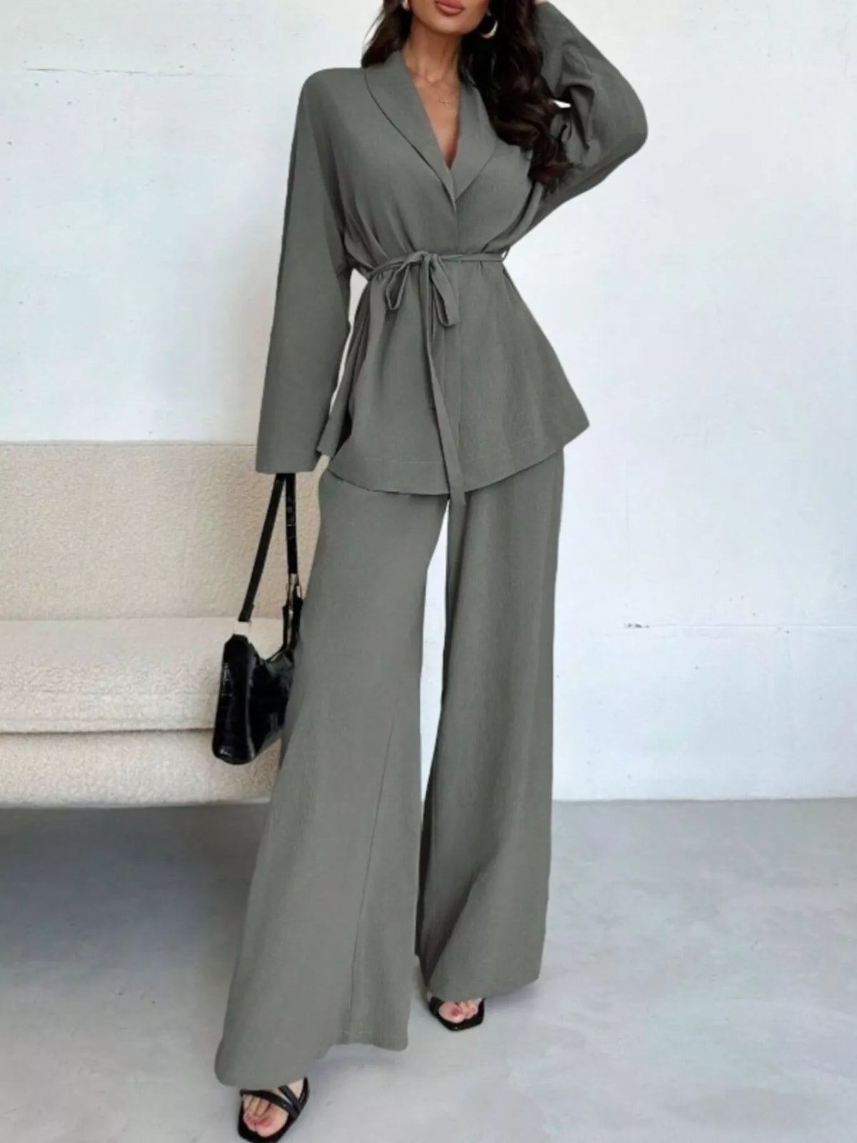 Textured tie waist top and wide-leg pants set for women from Trendsi, featuring a stylish, coordinated matching outfit.