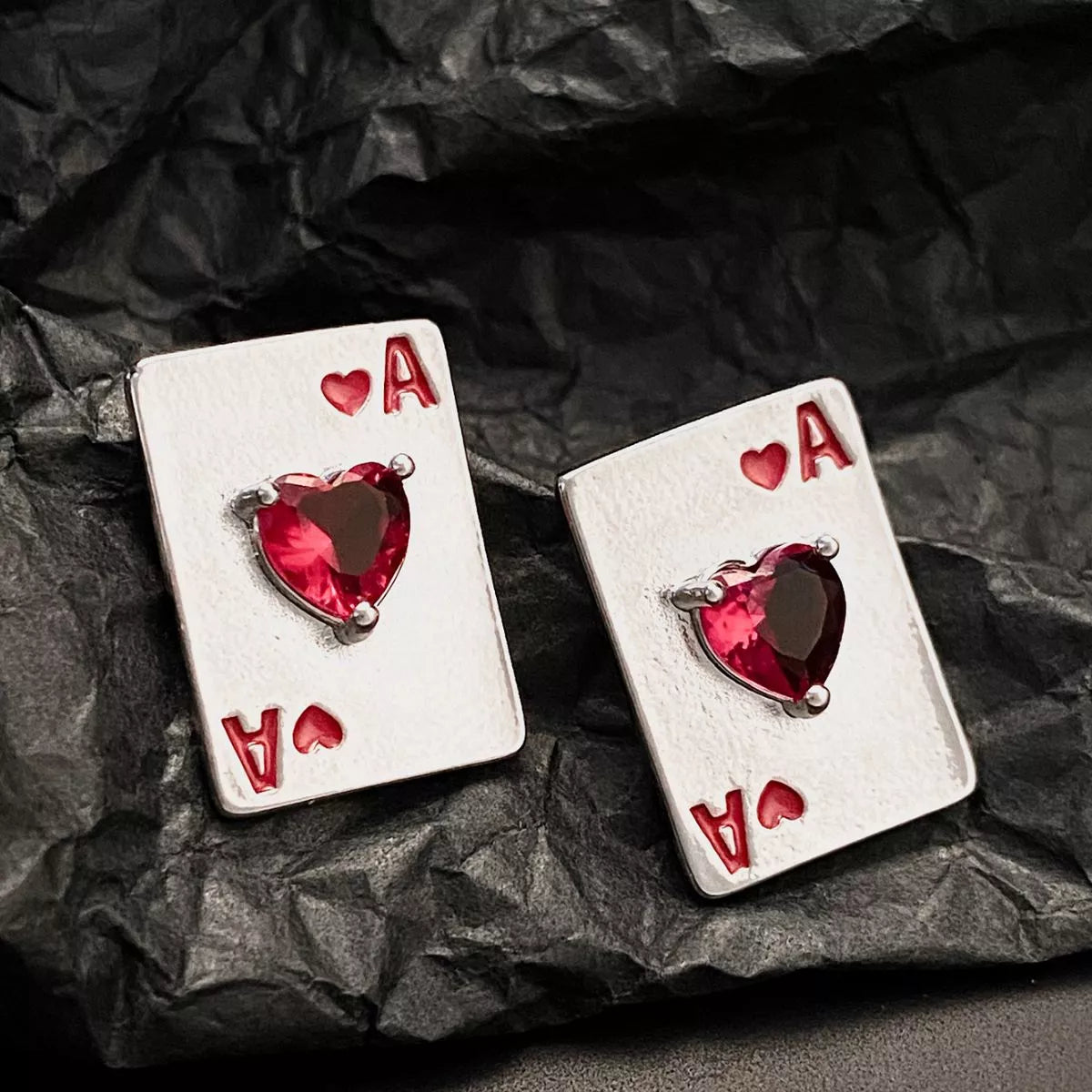 Plush Fashion Hub Ace of Hearts poker card stud earrings featuring gold-tone metal and detailed playing card design.
