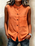 Women's sleeveless crop top with buttoned pockets in solid color, casualwear by FitiqueFit, shown in water background.
