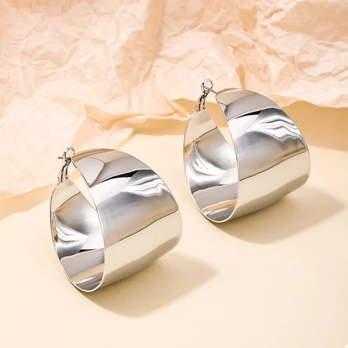 Plush Fashion Hub alloy wide hoop earrings showing shiny gold finish and large circular design.