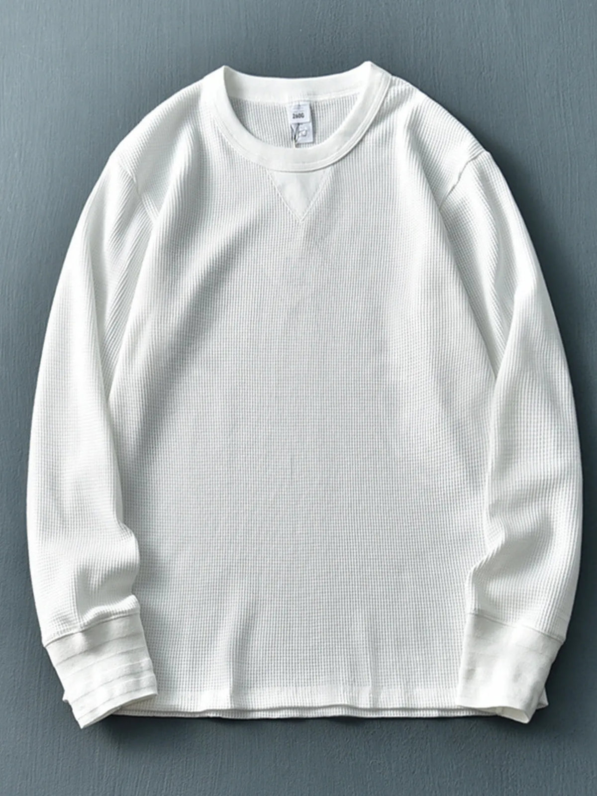 Men's plus size round neck long sleeve T-shirt by Trendsi, in a comfortable fit with a classic design, displayed on a neutral background.