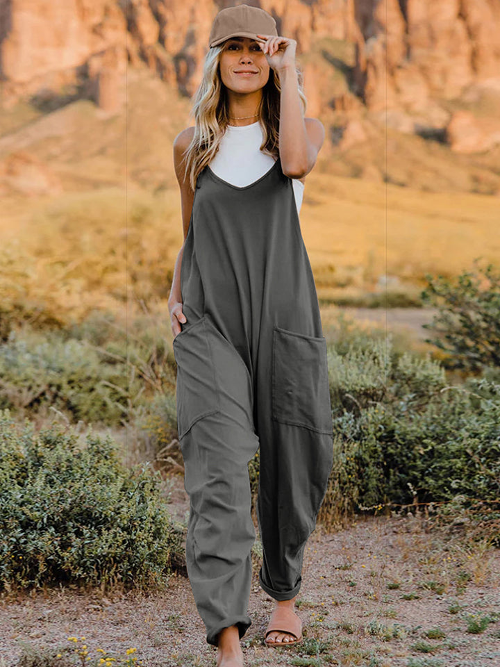 Women’s sleeveless V-neck wide-leg jumpsuit with pockets from Plush Fashion Hub, shown in a stylish, relaxed fit.
