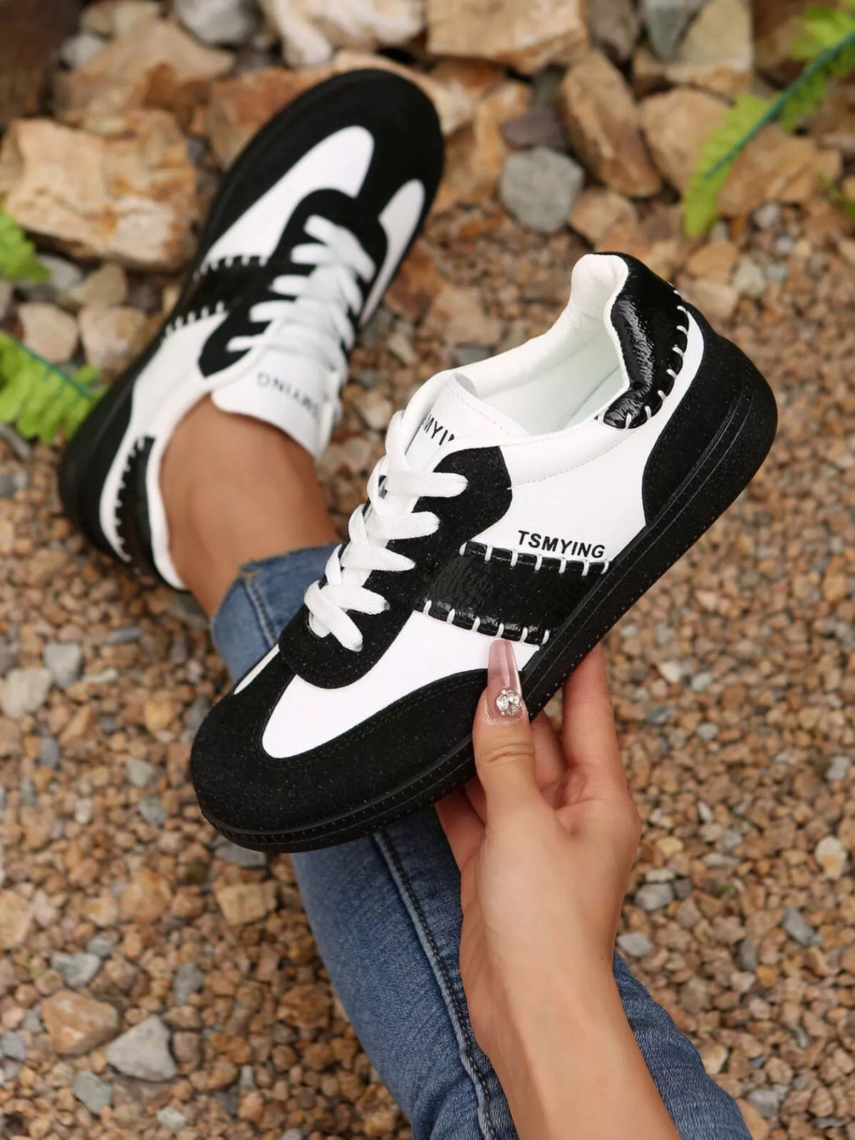 Contrast lace-up sneakers from Trendsi featuring stylish design, white and black color blocking, and comfortable footwear for casual wear.
