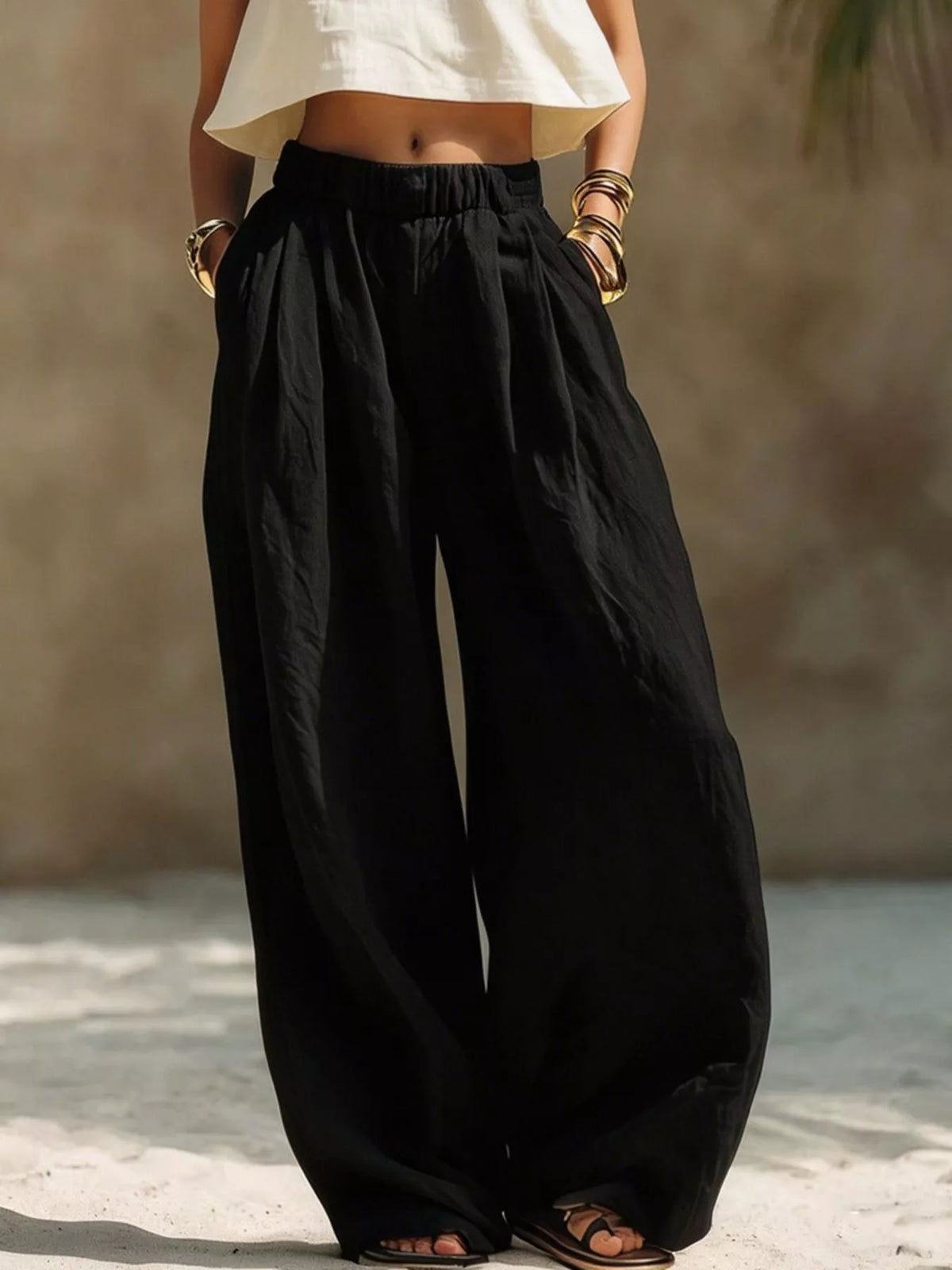 Plus size wide-leg pants with full elastic waistband, flowing fabric, and relaxed fit from Trendsi.