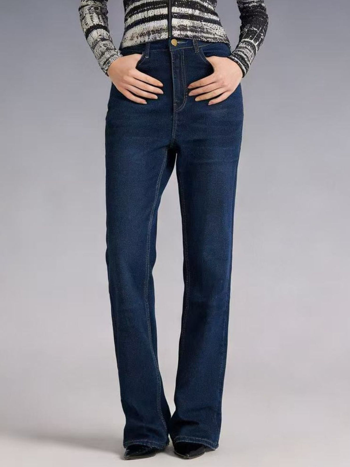 Plush Fashion Hub high-waisted bootcut denim jeans displayed on a hanger, showcasing classic blue fabric and fitted design.