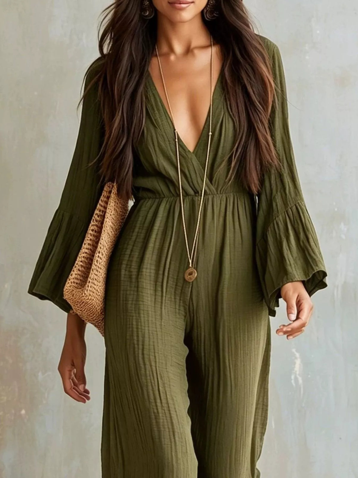 Textured flare sleeve jumpsuit for women, featuring a fitted waist and wide-leg design, displayed on a mannequin.