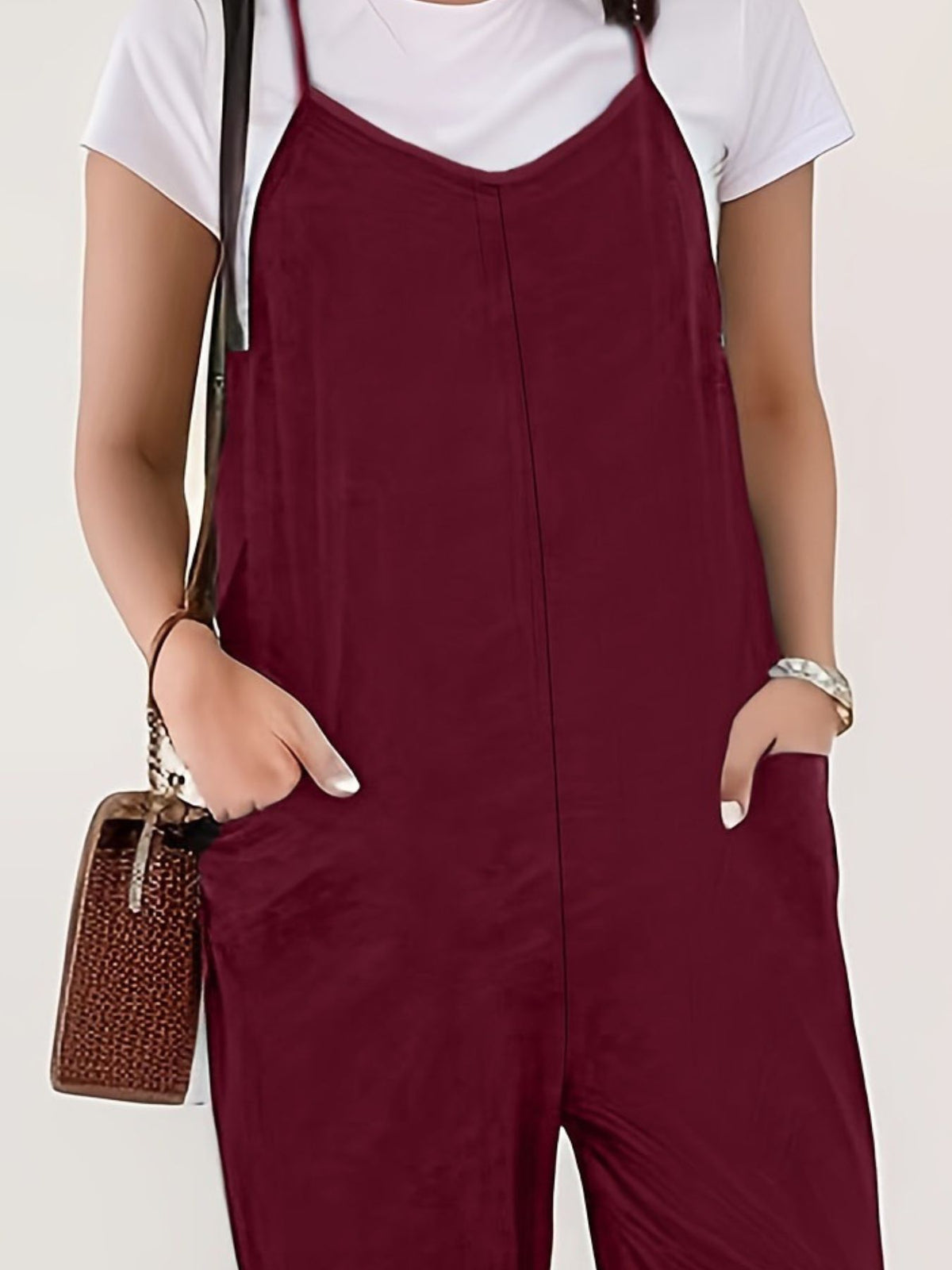 Casual loose fit spaghetti strap jumpsuit with pockets from Plush Fashion Hub, featuring a relaxed style and lightweight fabric.