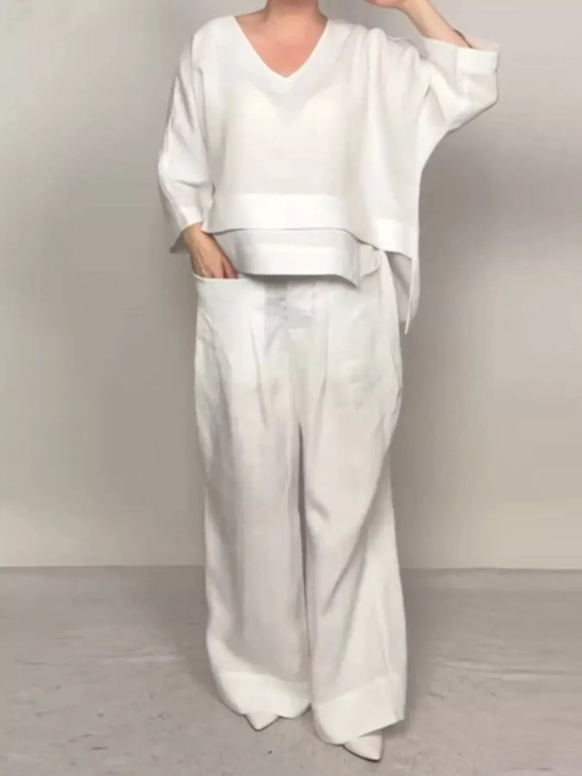 Plus size full V-neck long sleeve top and pants set by Trendsi, stylish matching clothing ensemble with comfortable fit.