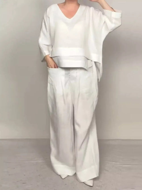 Plus size Trendsi V-neck long sleeve top and pants set, featuring comfortable full-size pants with a relaxed fit.