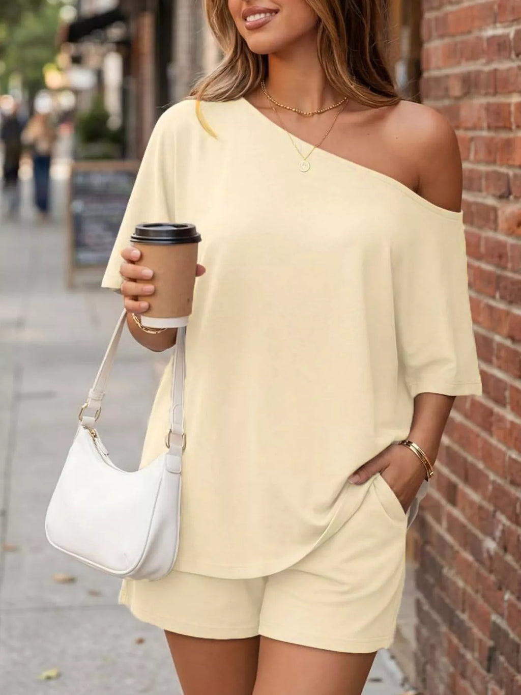Plus size one-shoulder top and matching shorts set by Trendsi, featuring a stylish design perfect for casual wear.