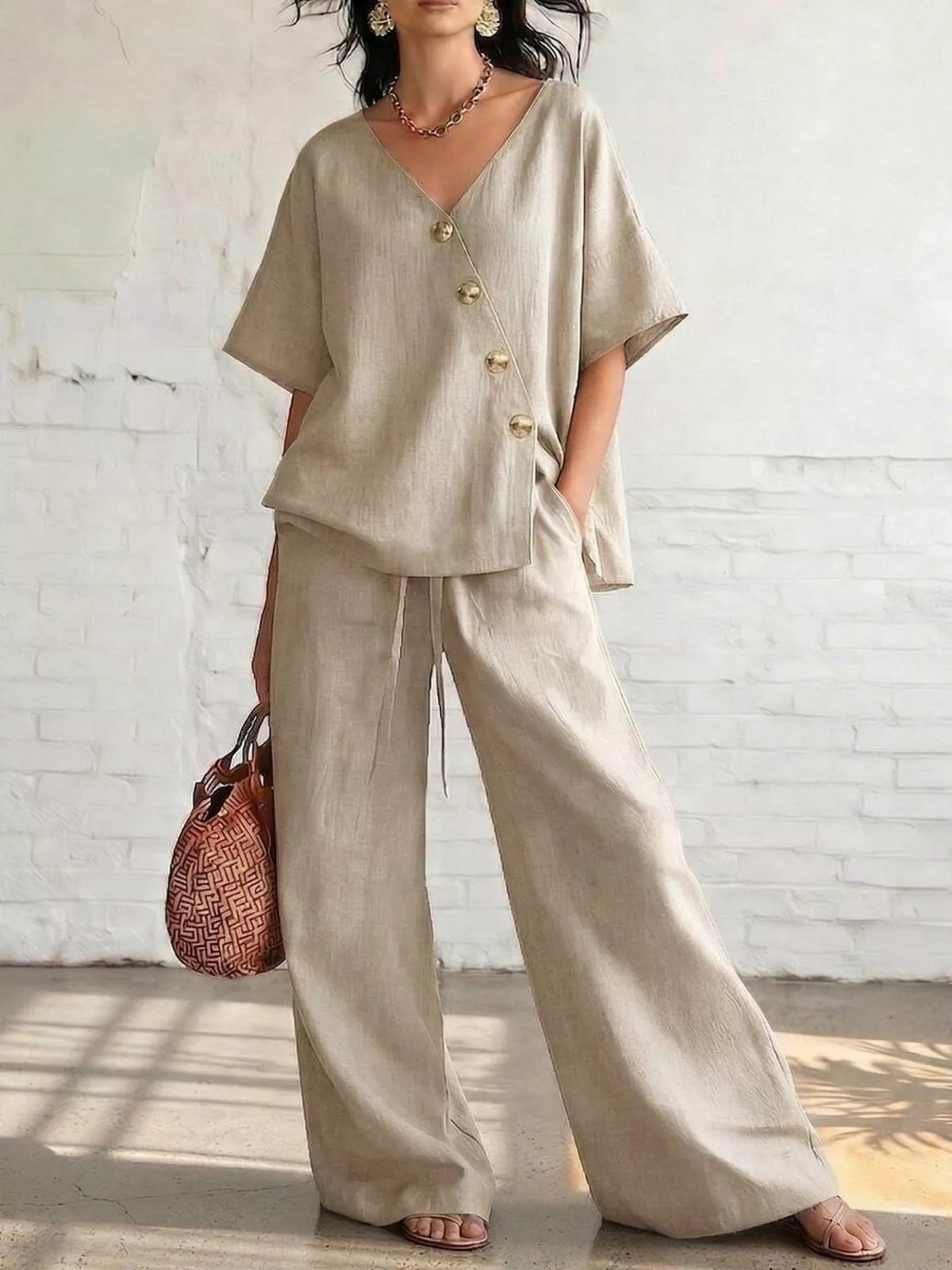 Plus size full surplice half sleeve top and wide-leg pants matching set by Trendsi, shown in a stylish, comfortable outfit.