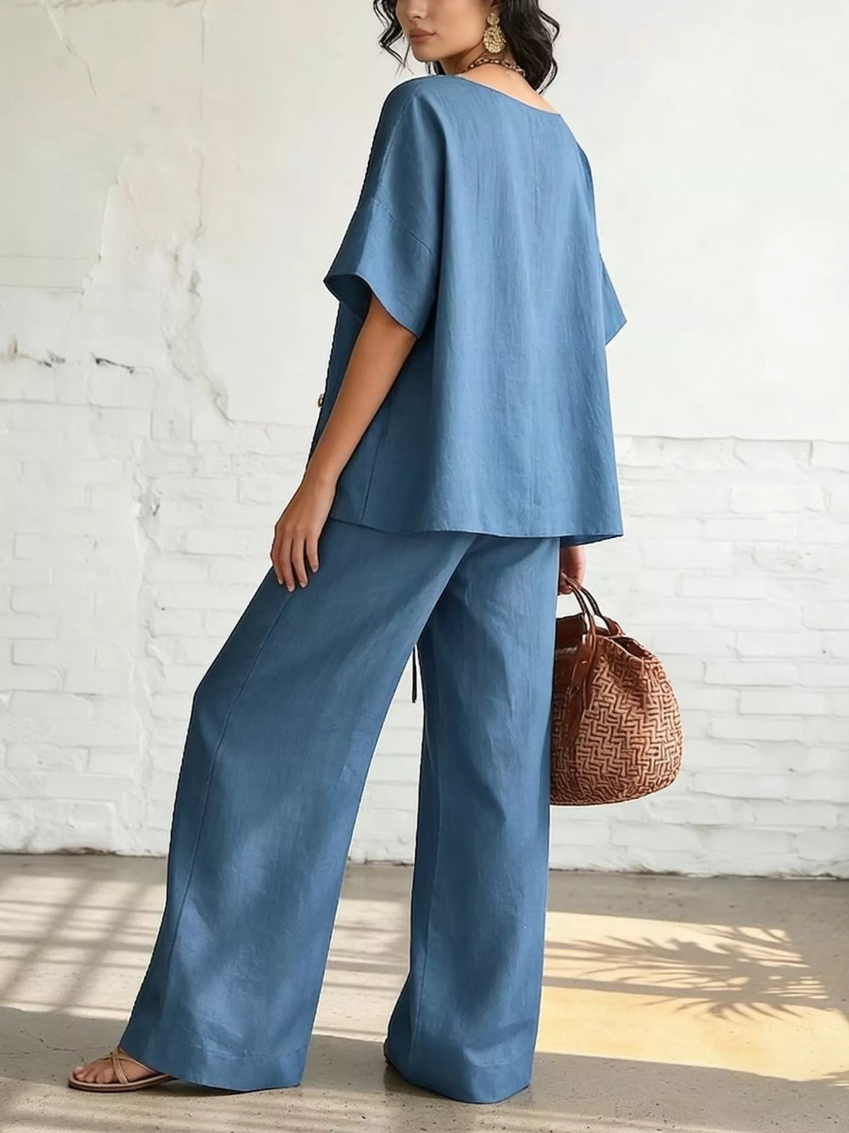 Plus size full surplice half sleeve top with wide-leg pants matching set by Trendsi, featuring a stylish, comfortable ensemble.