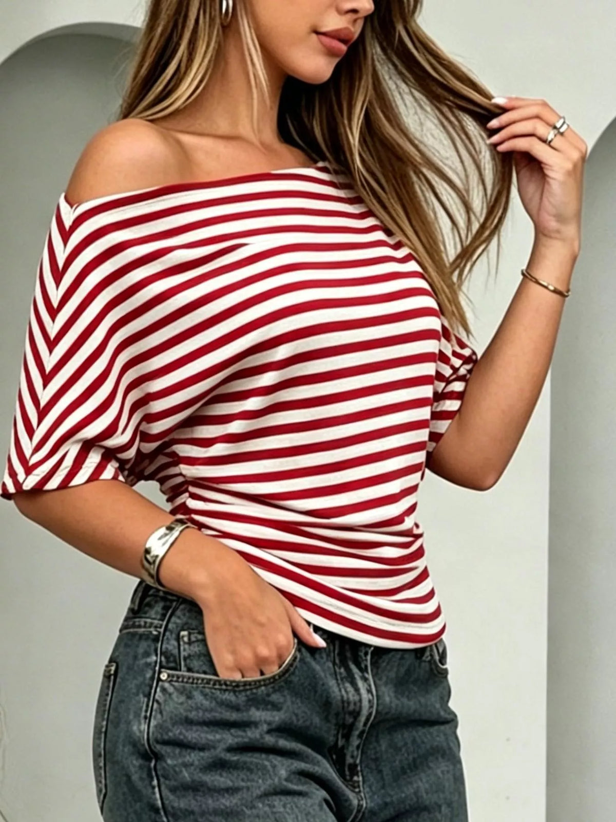 Striped one-shoulder dolman sleeve t-shirt by Plush Fashion Hub, featuring a stylish asymmetrical design and soft fabric.