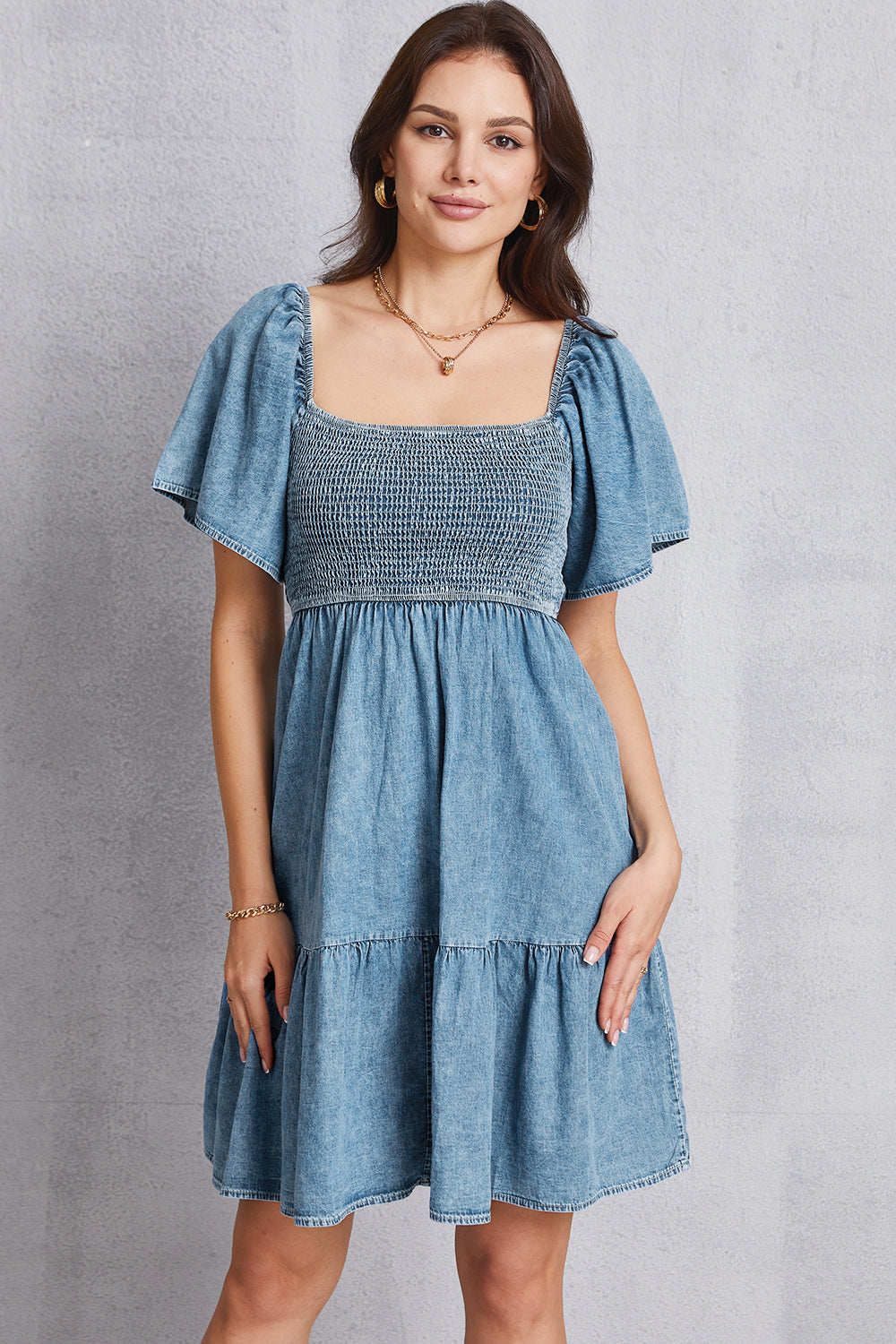 Smocked square neck mini denim dress by Plush Fashion Hub, featuring sleeveless design, fitted bodice, and casual style.