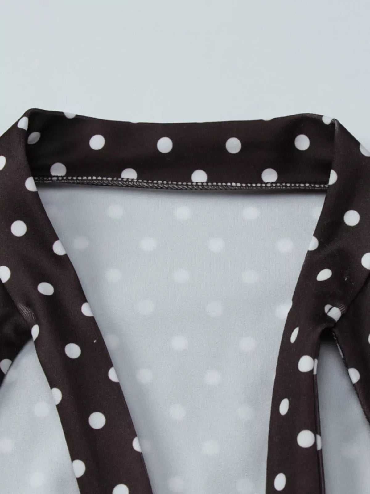 Polka dot cut-out front mini dress by Plush Fashion Hub showing the stylish dress with a fitted silhouette and playful polka dot pattern.