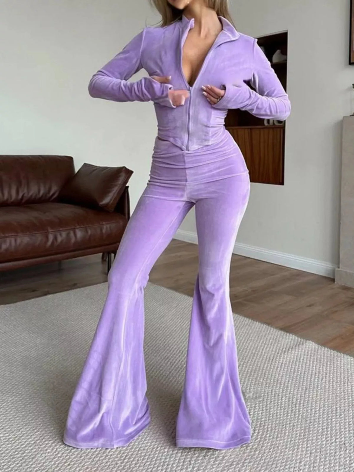 Trendsi zip-up crop top and flared pants two-piece set, stylish matching outfit with fitted crop top and wide-leg pants.