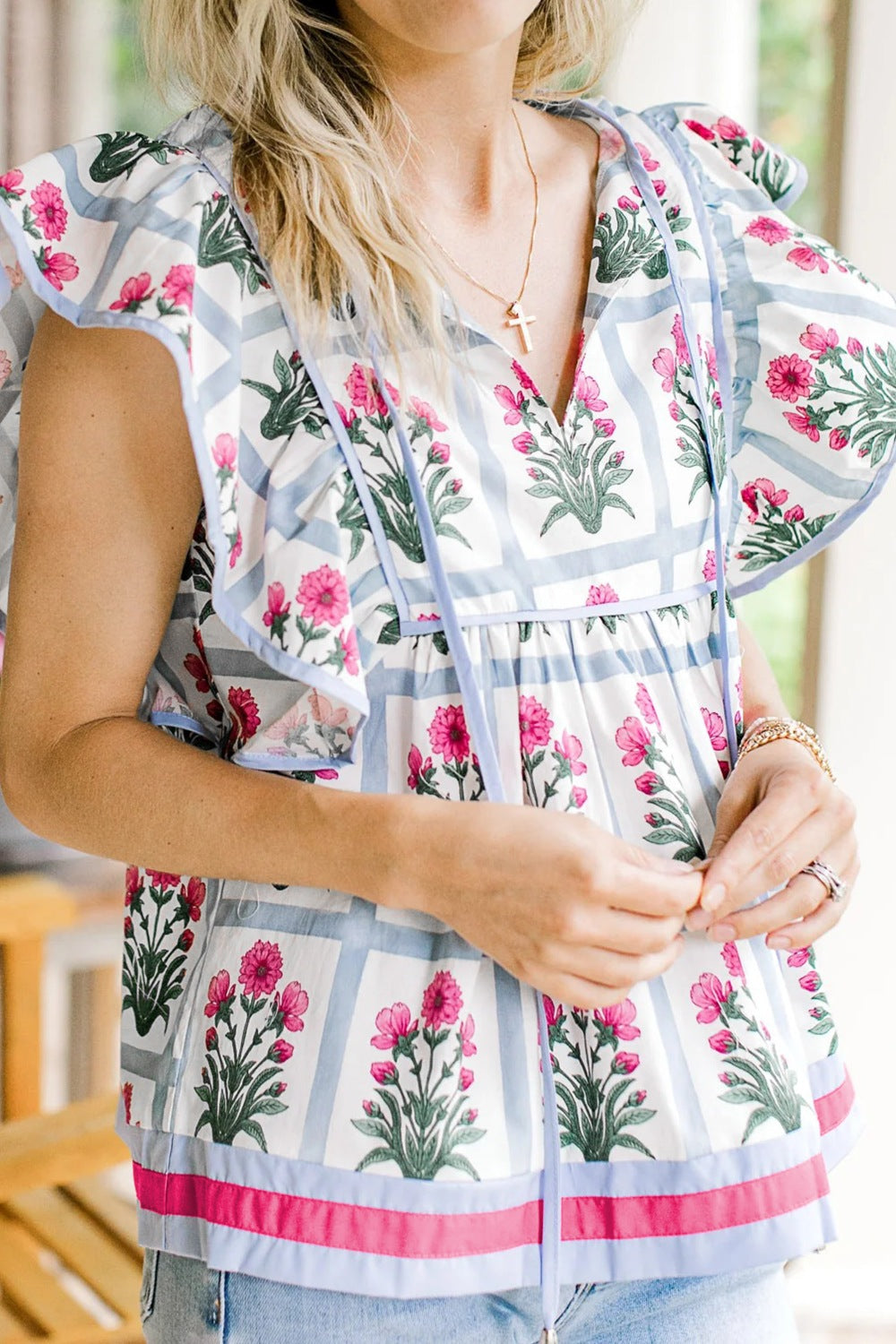 Women’s floral print blouse with ruffle sleeves and tied neckline, lightweight fabric, by Plush Fashion Hub.