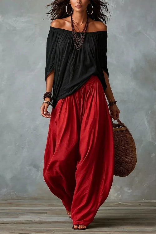 Plus size off-shoulder top and wide-leg pants set by Trendsi, featuring a stylish and comfortable coordinated outfit.