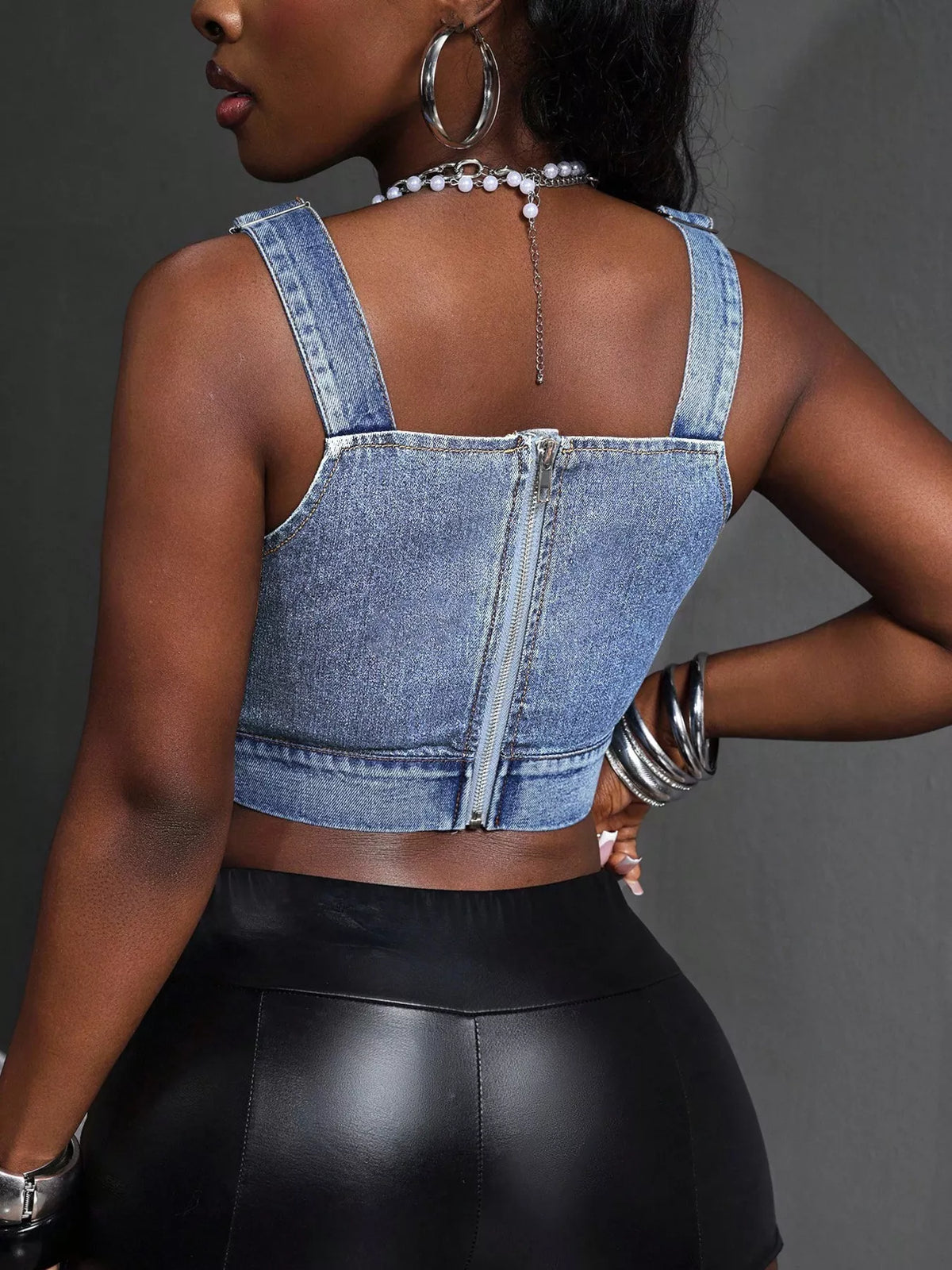 Plush Fashion Hub cropped denim top with adjustable straps, casual shirt featuring a trendy, stylish design and light blue denim fabric.