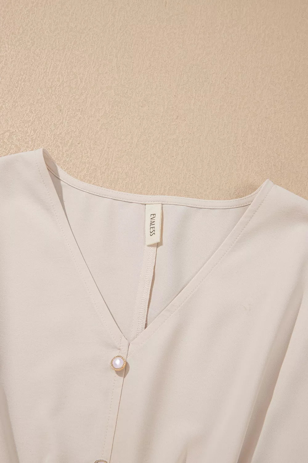 Plush Fashion Hub V-neck long sleeve blouse with smocked waist, elegant style, in soft fabric, perfect for chic casual or formal wear.