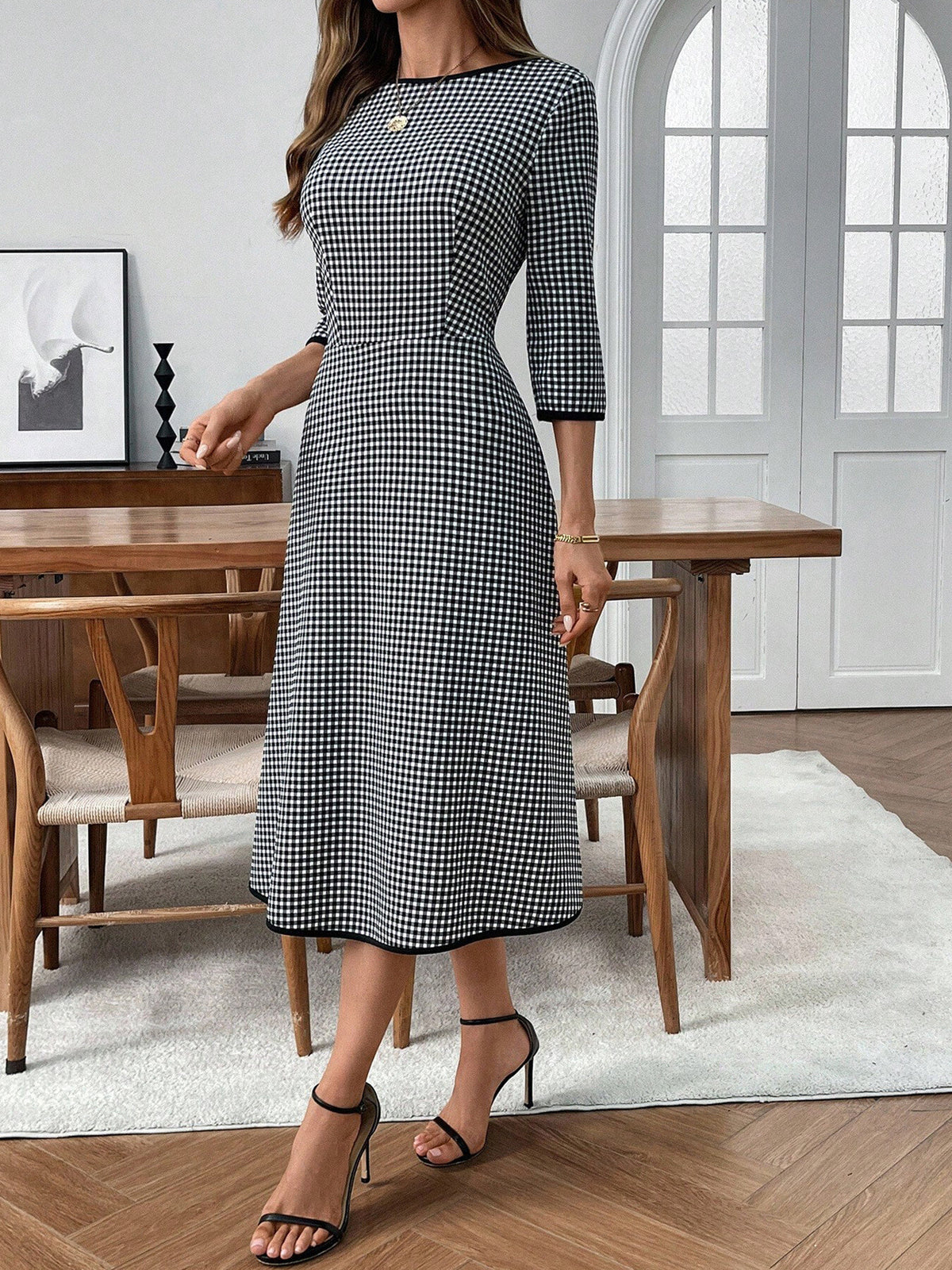 Plaid round neck midi dress with 3/4 sleeves from Plush Fashion Hub, featuring a classic plaid pattern and a relaxed fit.
