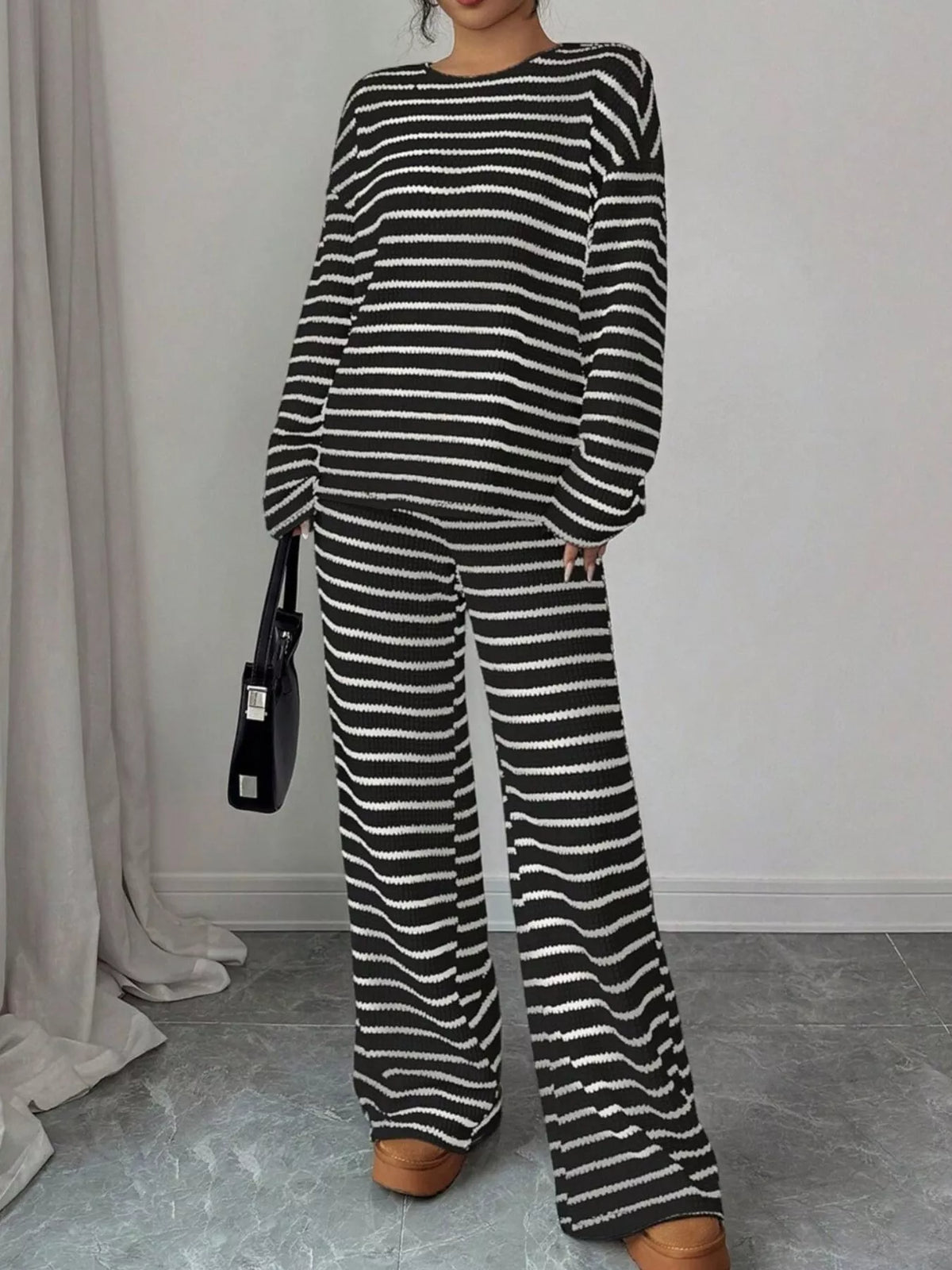 Striped knit dropped shoulder top and pants set by Trendsi, featuring a cozy, casual look with a relaxed fit and stylish design.