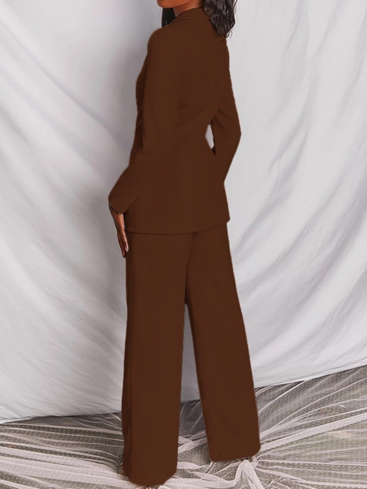 Plus size blazer and wide-leg pants matching set by Trendsi, featuring a one-button blazer and flowy wide-leg trousers.
