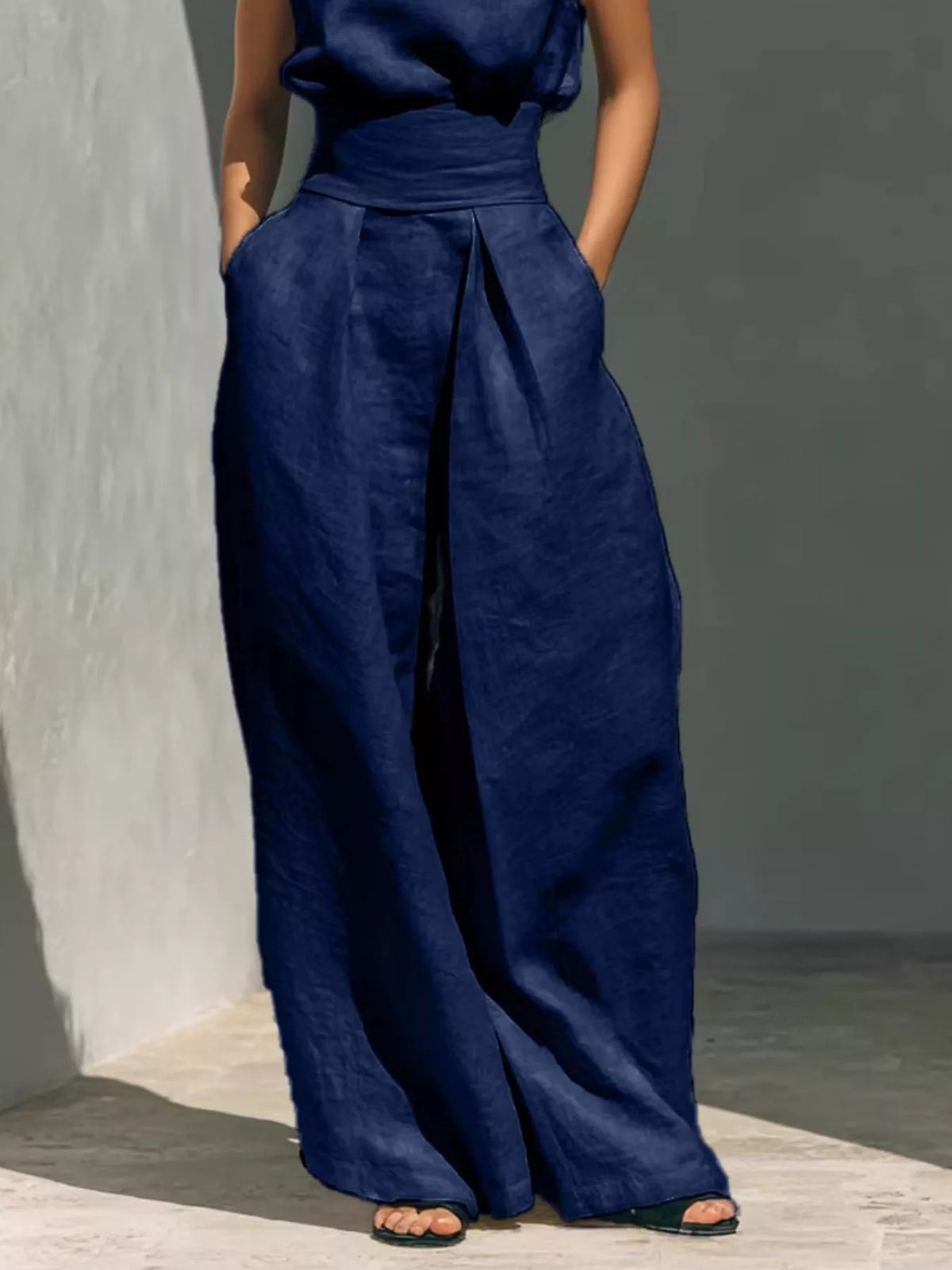 Plus size sleeveless jumpsuit with wide-leg design and smocked waist, Trendsi full-length jumpsuit for a comfortable, stylish look.