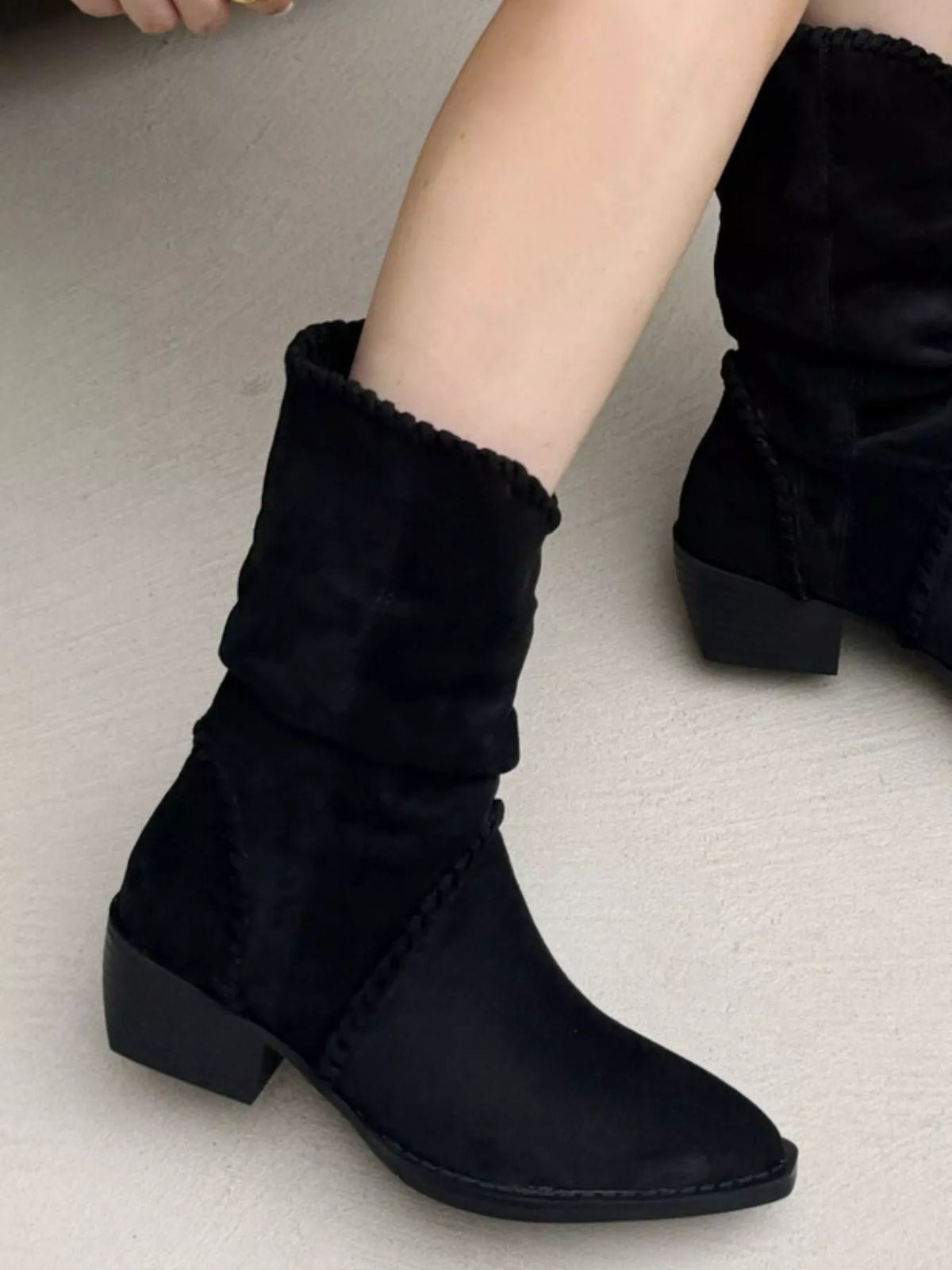Point toe block heel boots by Trendsi featuring sleek black leather with a stylish pointed toe design and sturdy block heel.