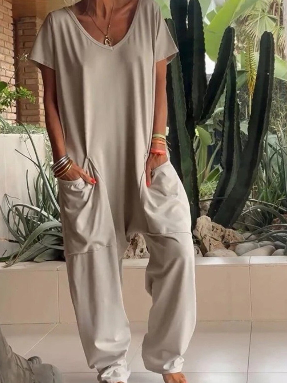 Plus size loose fit V-neck short sleeve jumpsuit with wide legs, trendy and comfortable from Trendsi.