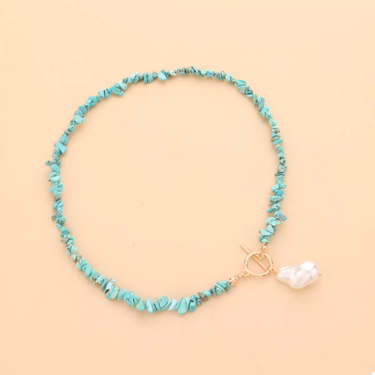 Turquoise irregular pearl necklace by Plush Fashion Hub featuring unique-shaped pearls on a stylish necklace design.