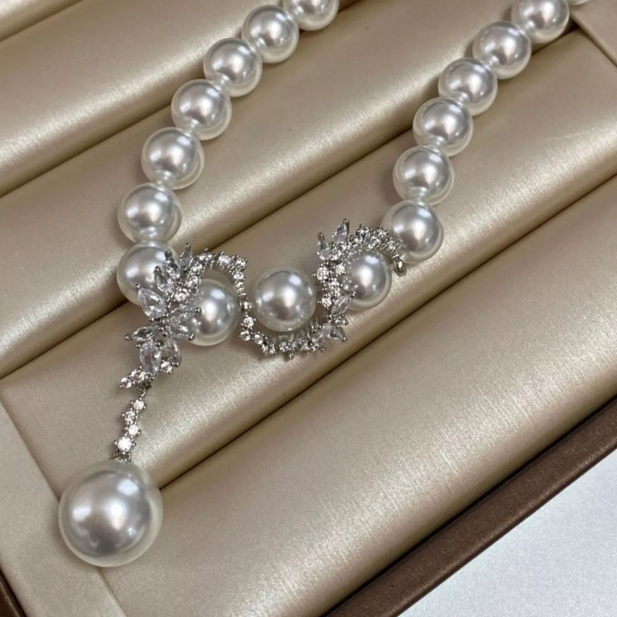 Elegant zircon pearl necklace from Plush Fashion Hub featuring a string of shimmering pearls and sparkling zircon accents.