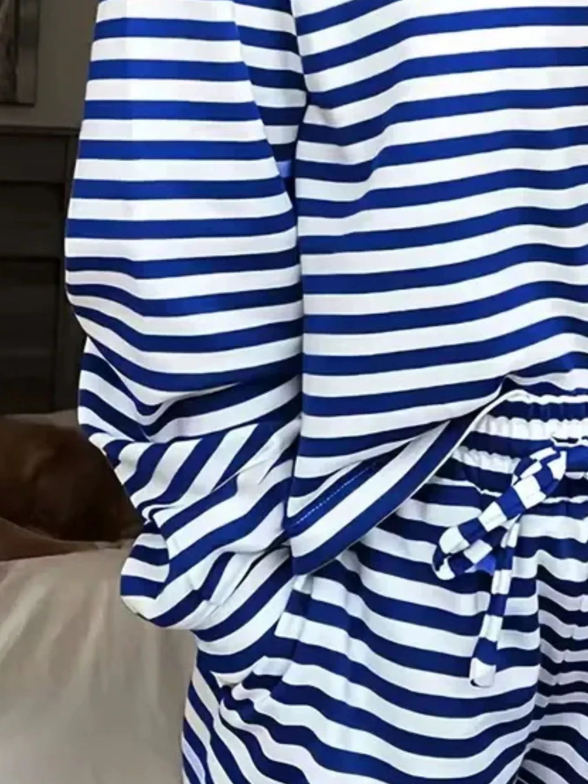 Striped dropped shoulder top and pants set by Trendsi, casual and stylish women's clothing ensemble with relaxed fit.