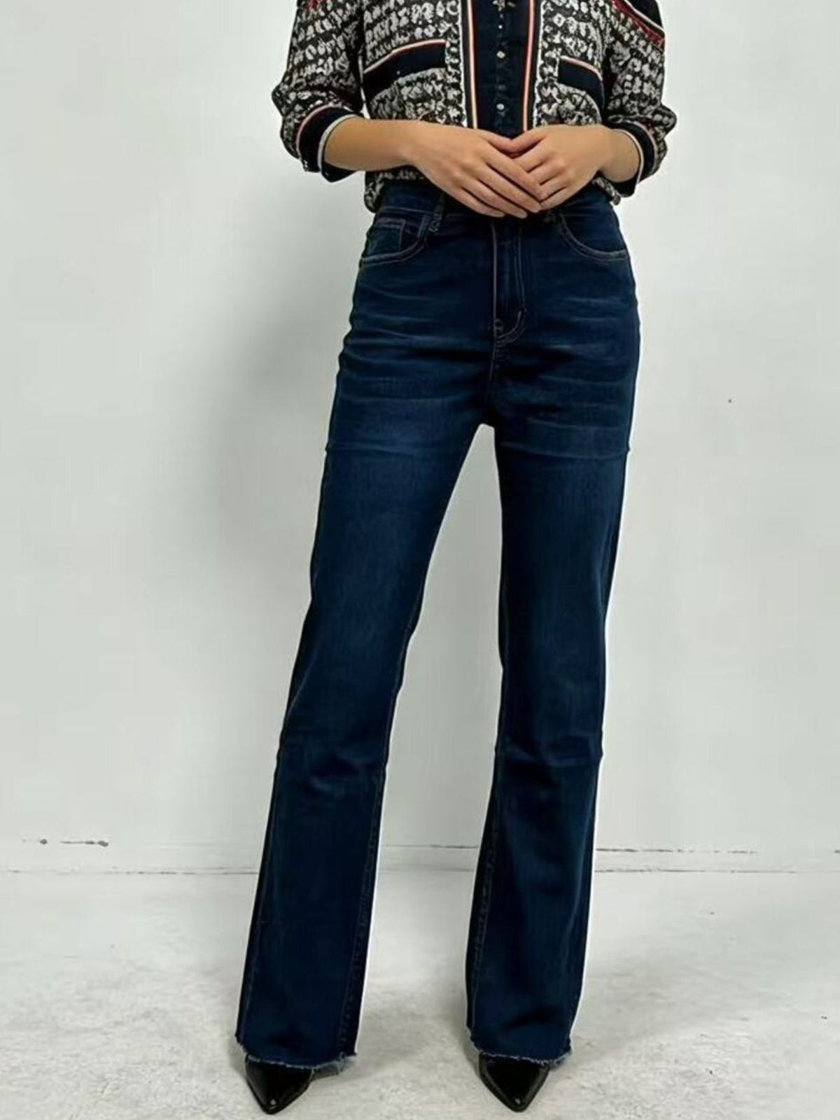 Plush Fashion Hub high-waisted bootcut denim jeans displayed on a hanger, showcasing classic blue color and fitted style.