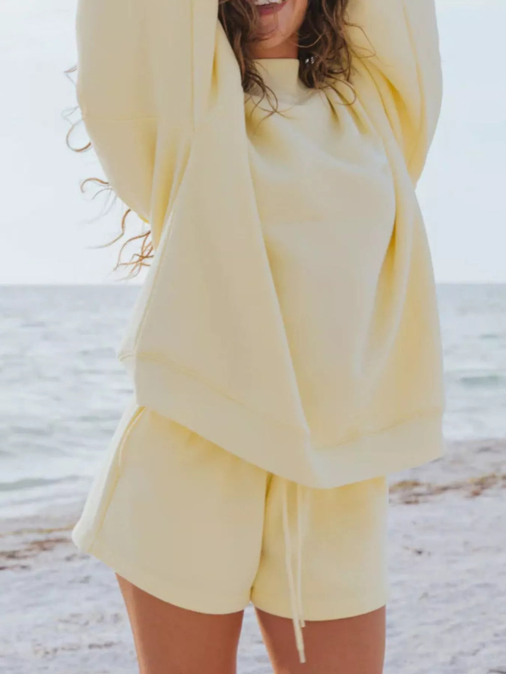 Relaxed fit round neck sweatshirt and shorts set by Trendsi, featuring a casual 2-piece loungewear in soft fabric.