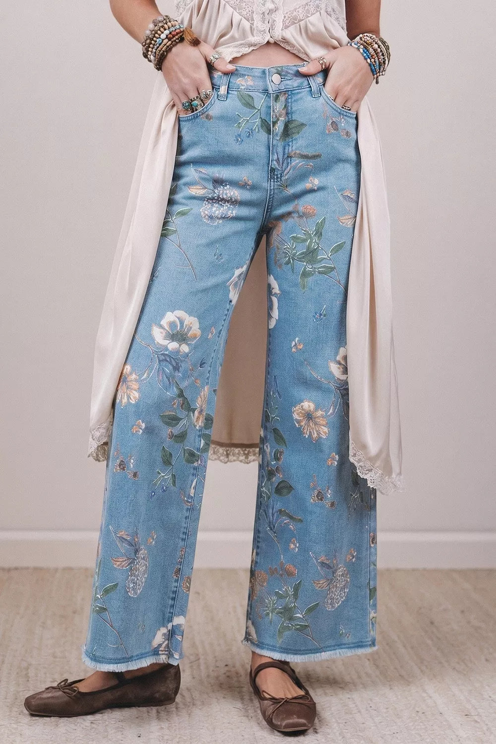 Floral print wide-leg jeans from Trendsi featuring a relaxed fit, high waist, and vibrant floral design.