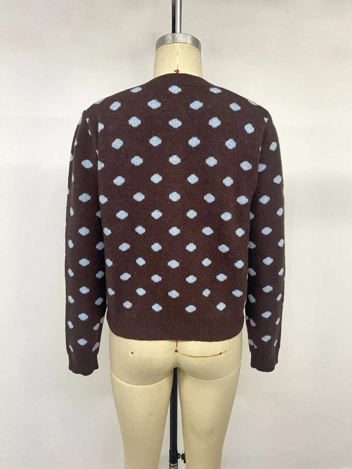 Women’s polka dot button-up cardigan by Trendsi, featuring a classic design with black and white polka dots and button closure.