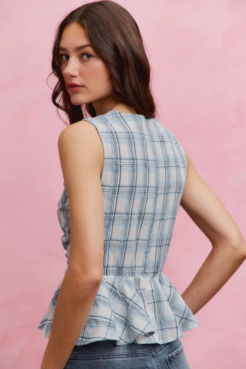 Plaid sleeveless ruffle peplum top by Plush Fashion Hub, featuring a stylish plaid pattern and feminine ruffle details.