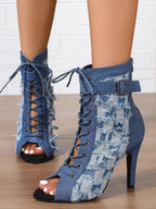 Distressed denim lace-up peep toe high heel ankle boots from Trendsi, featuring a stylish rugged look and open toe design.