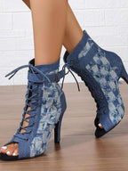 Distressed denim lace-up peep toe ankle boots with high heels, stylish shoe by Trendsi featuring a rugged, trendy design.