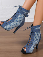 Distressed denim lace-up peep toe high heel ankle boots from Trendsi, featuring a rugged look and stylish design.
