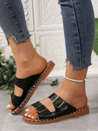 Women's double buckle flat sandals by Trendsi featuring adjustable straps and comfortable walking design.