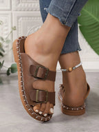 Women's double buckle flat sandals with adjustable straps, trendy walking shoes by Trendsi featuring comfortable design.
