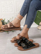 Women's double buckle flat sandals by Trendsi with adjustable straps and comfortable design, perfect for casual walking.