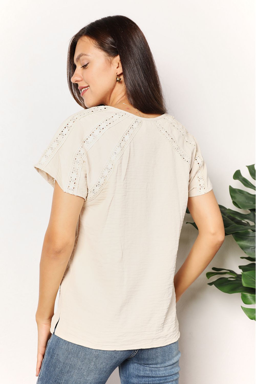Women's boho chic crochet button-down short sleeve top, trendy summer blouse with button details and lightweight fabric.