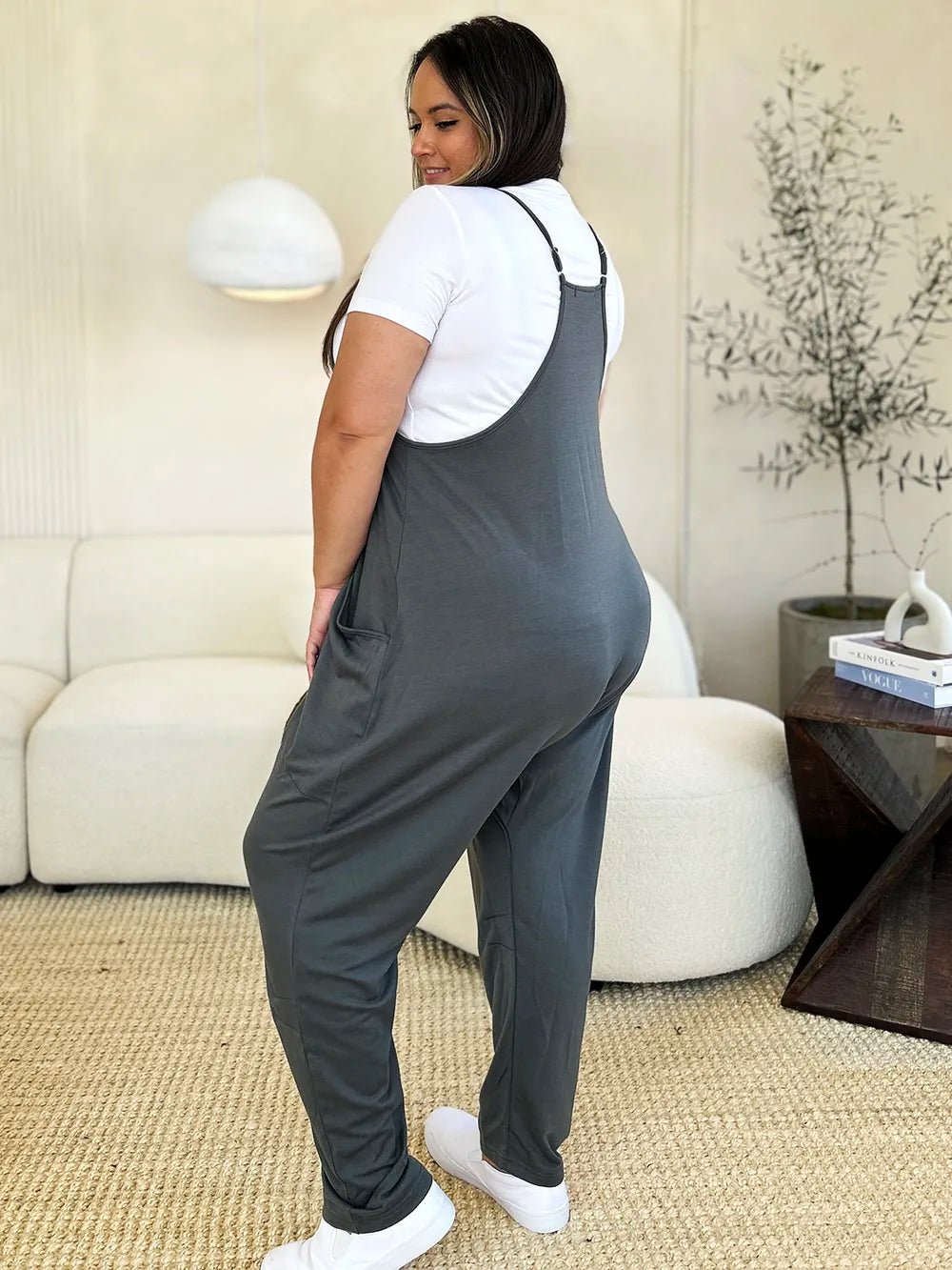 Women’s sleeveless V-neck wide-leg jumpsuit with pockets from Plush Fashion Hub, shown on a model in a full-length view.