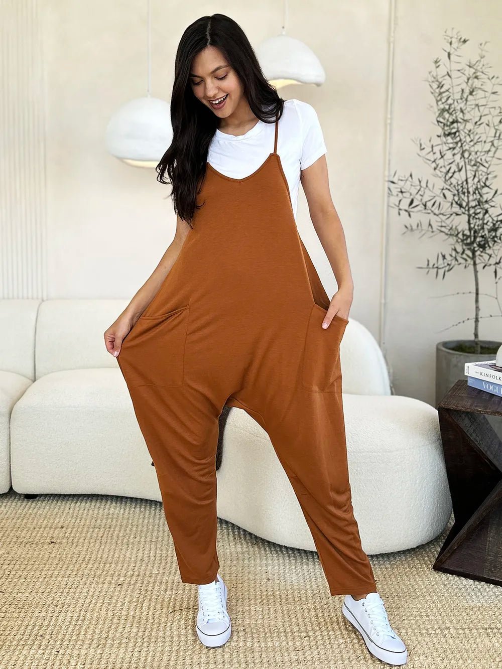 Women’s sleeveless V-neck wide-leg jumpsuit with pockets, by Plush Fashion Hub, shown on a model in a full-length view.