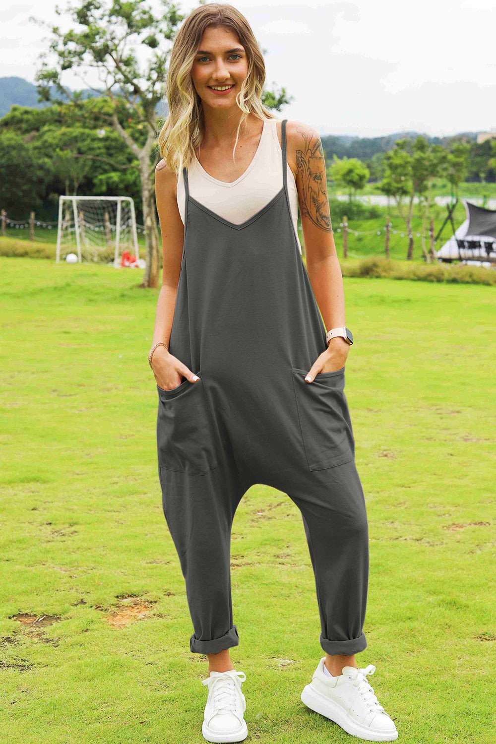 Women’s sleeveless V-neck wide-leg jumpsuit with pockets, stylish and comfortable, by Plush Fashion Hub, shown in full length.
