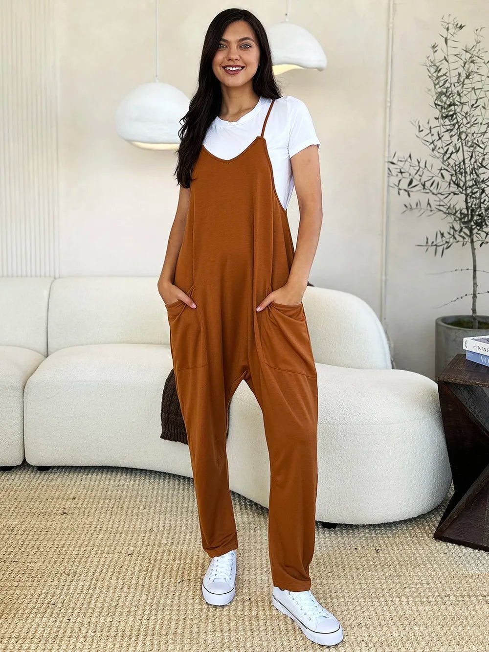 Women’s sleeveless V-neck wide-leg jumpsuit with pockets, stylish and comfortable, from Plush Fashion Hub.