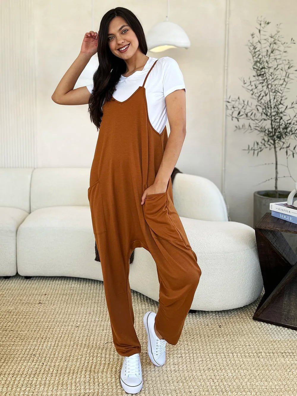 Women’s sleeveless V-neck wide-leg jumpsuit with pockets by Plush Fashion Hub, shown full-length on a model.